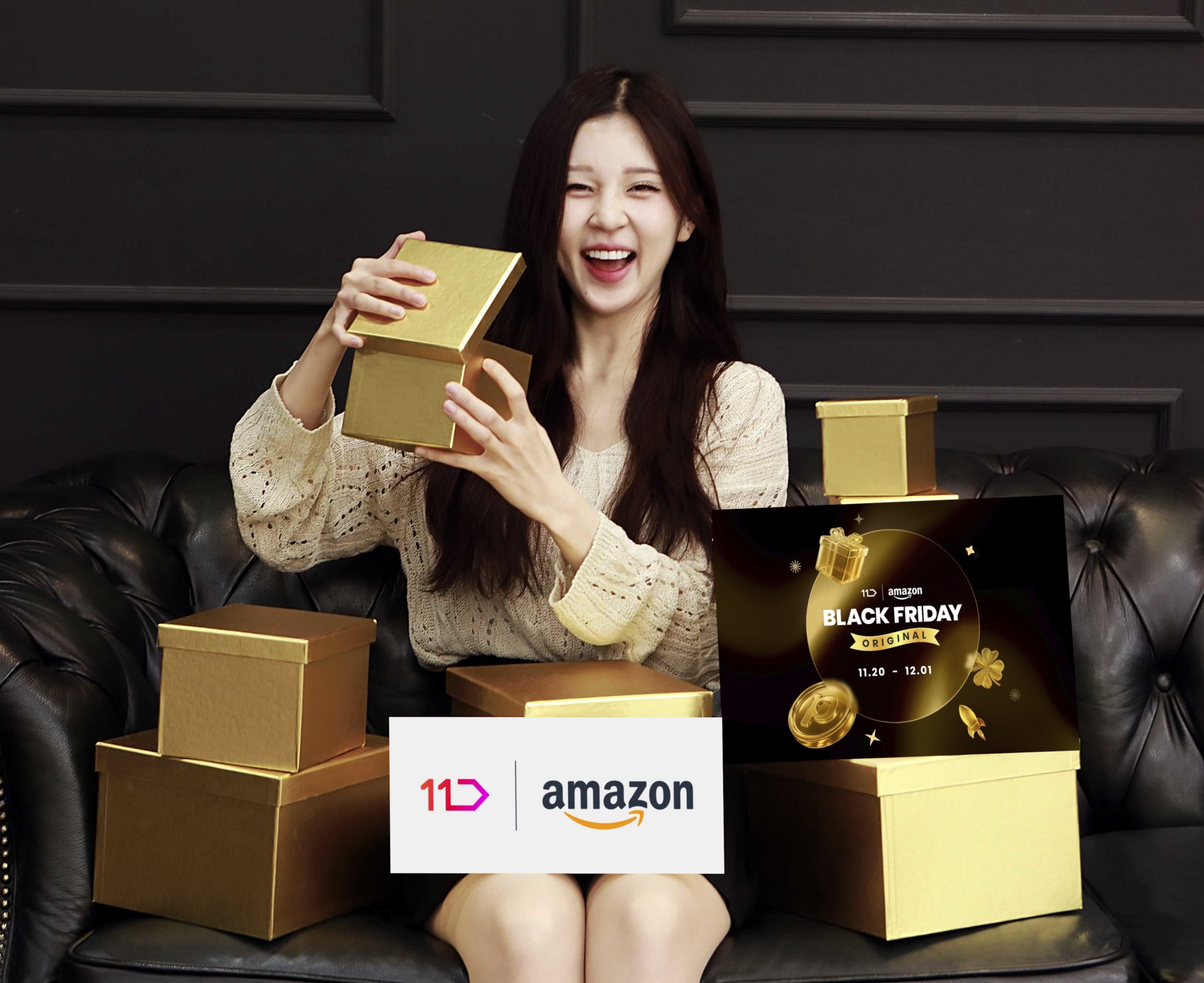 여성모델이 황금색 선물상자를 열며 11번가와 아마존이 함께하는 블랙프라이데이 오리지널을 홍보하고 있다